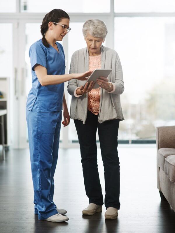 Healthcare working alongside an older patient
