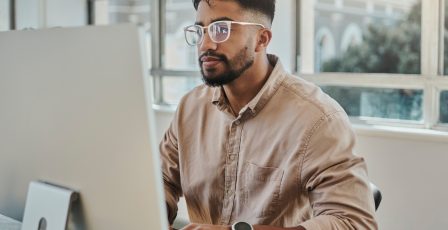 Young man using a desktop computer to browse the internet