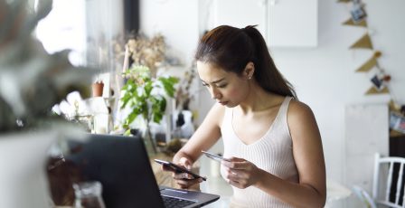 Young woman shopping online from her mobile phone