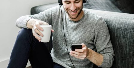 Young man online gaming on his smart device