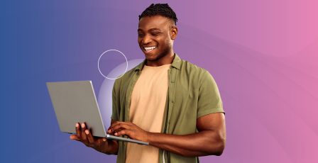 Man browsing on a laptop in front of a blue and pink gradient background