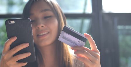 Woman using mobile phone to shop online