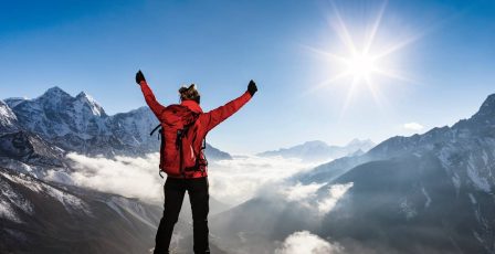 Person standing on top of a mountain