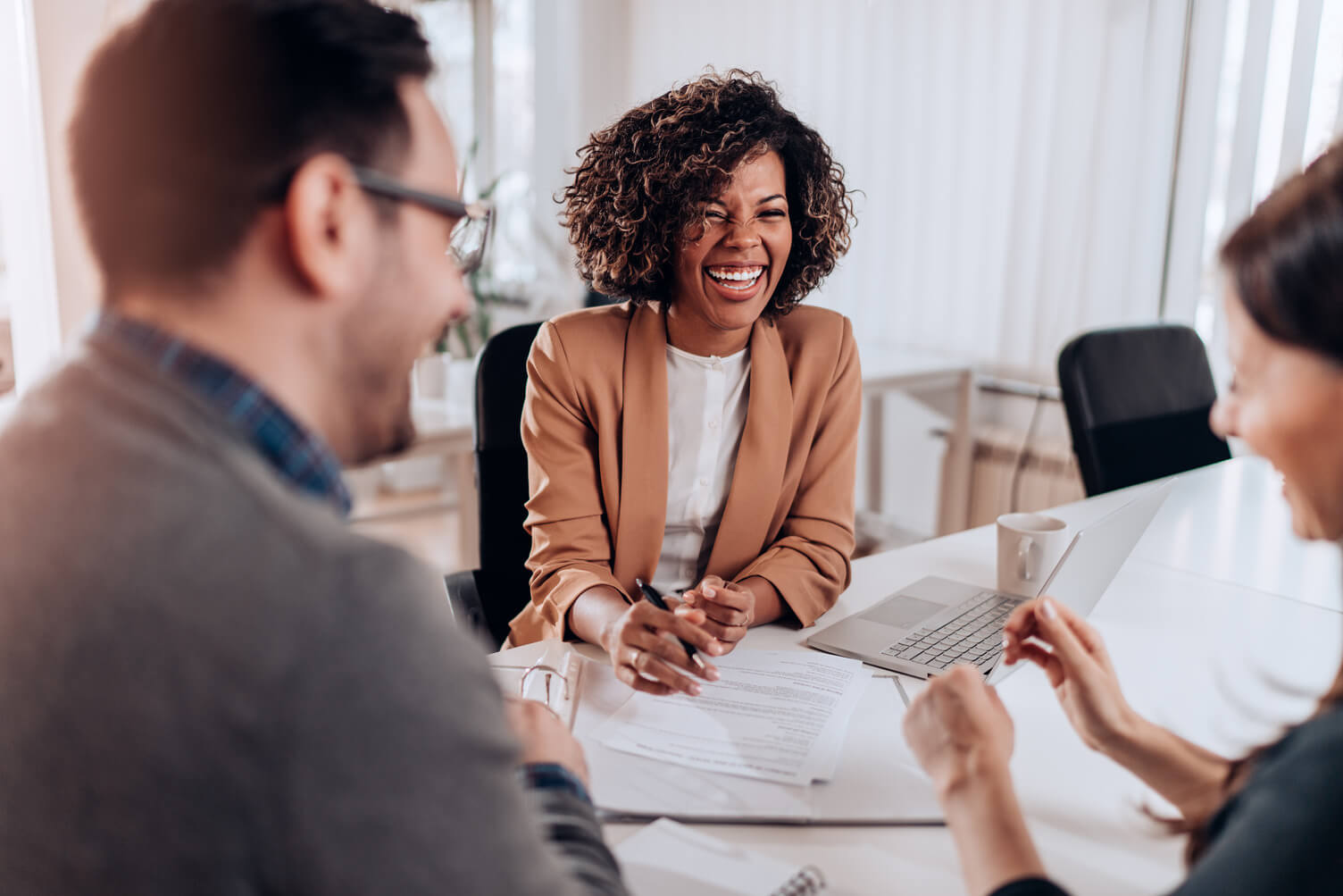 Employee in a bank helping a couple with their application