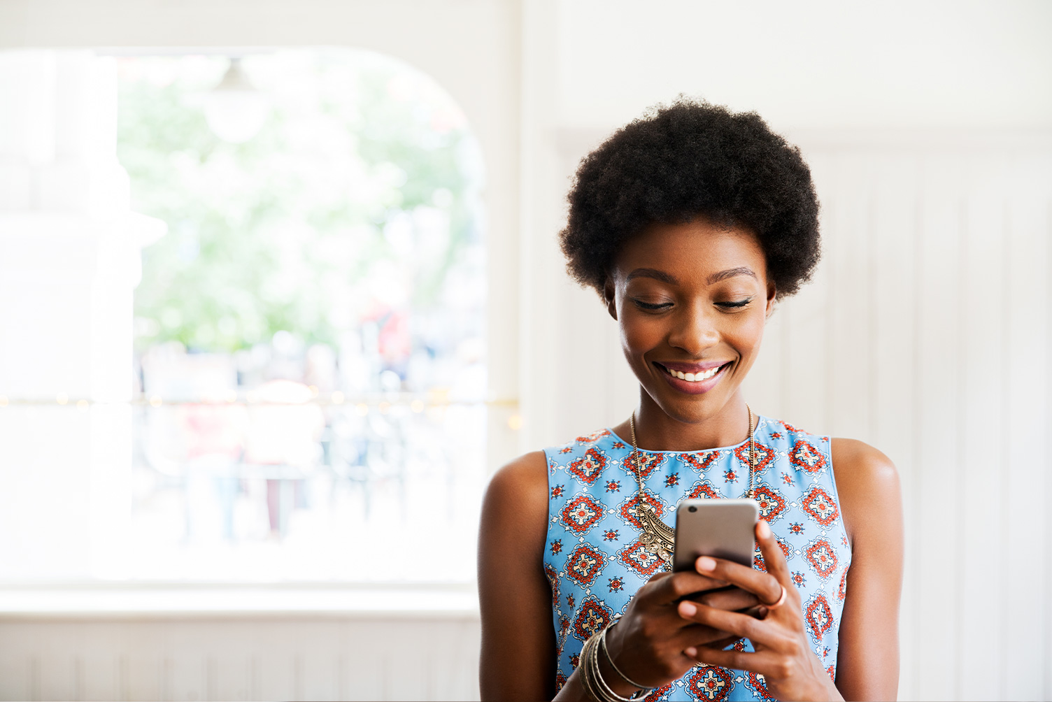 Woman sat using her phone at home