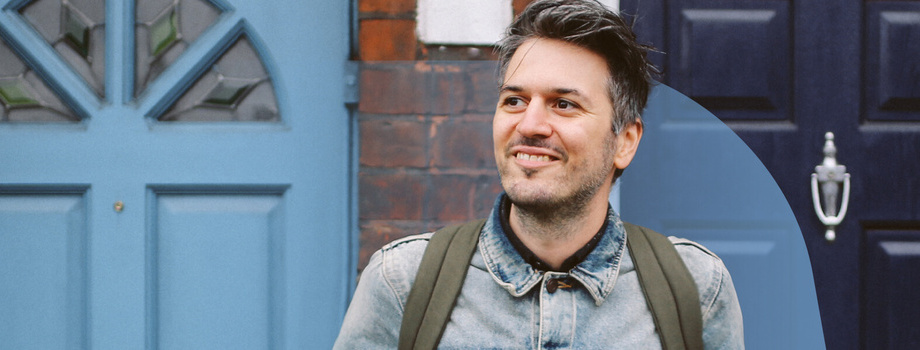 Man smiling outside front door