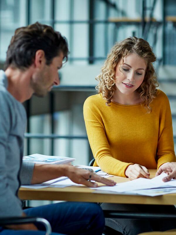 Two colleagues looking at credit reports