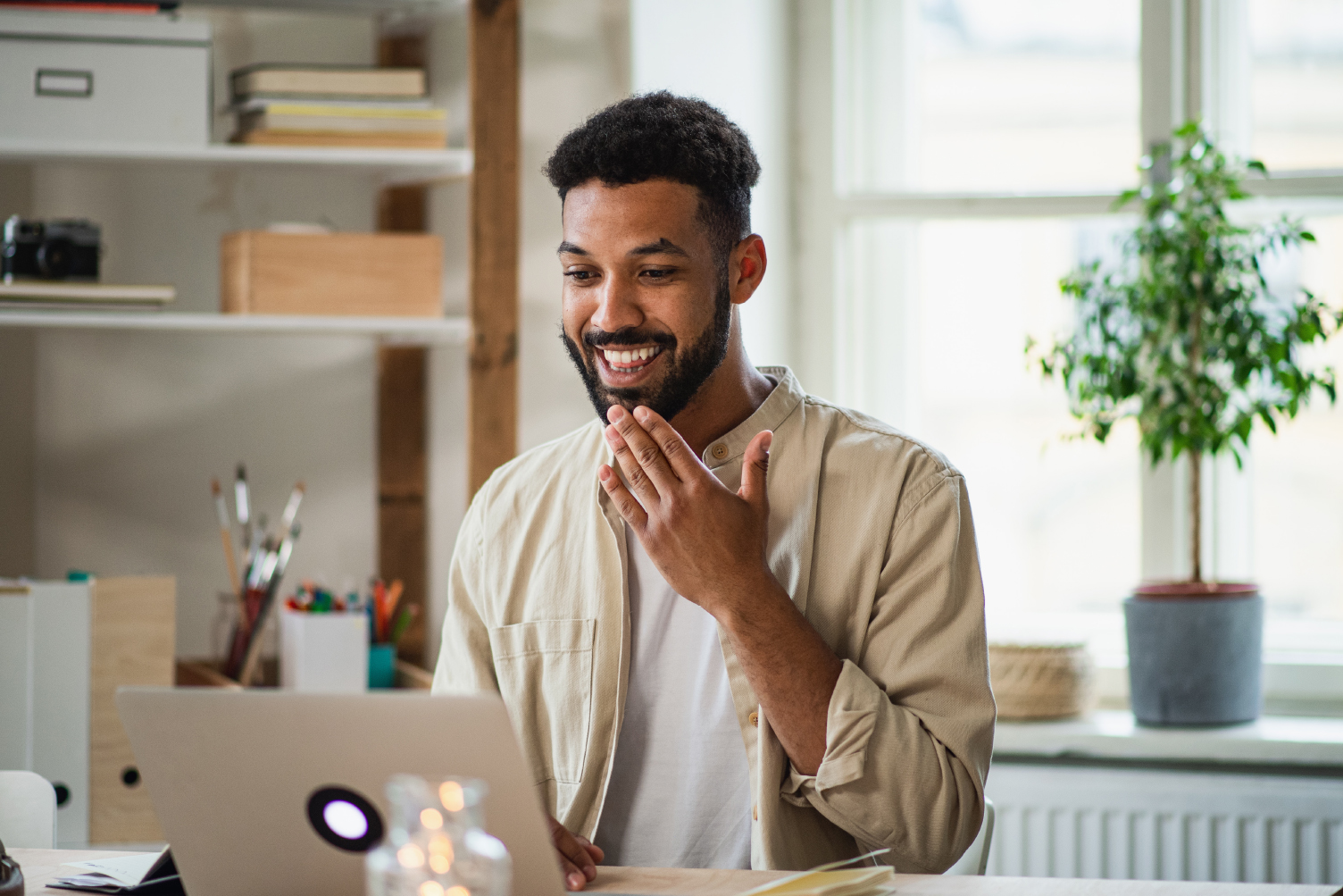 Man taking a video call while using sign language