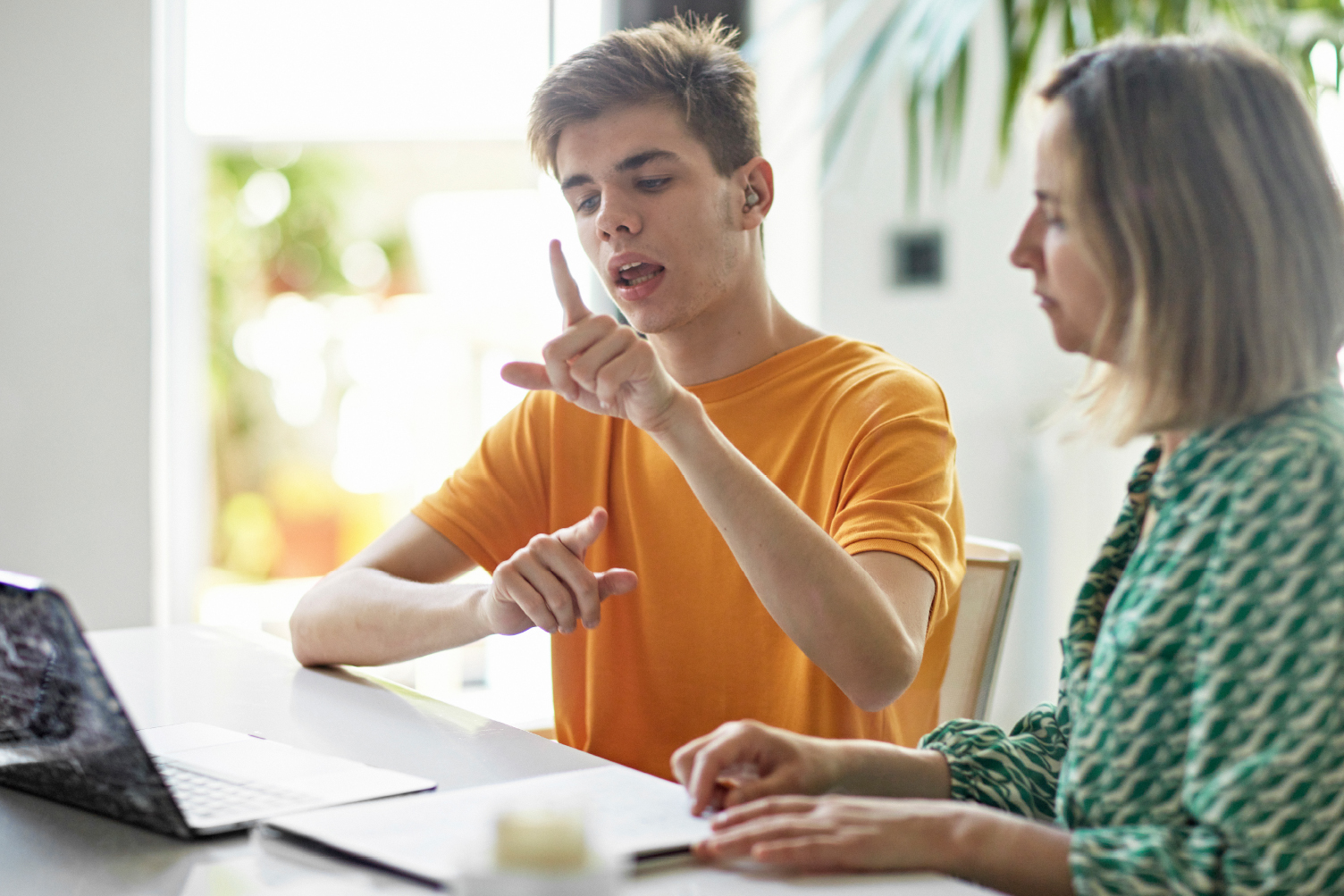 Two people having a conversation through sign language